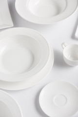 high angle view of various plates and cup on white table