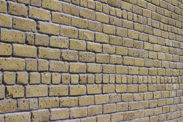Angle view of an antique beige white brick wall background with grunge look
