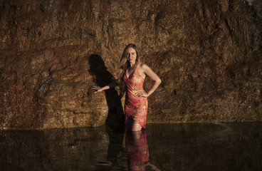 girl in a dress by the waterfall