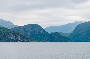 Mountain landscape of the fjord on a cloudy day.  A multi-planed landscape. Monstraumen, Hordaland country, Norway, Europe.