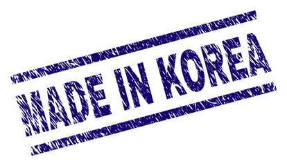 MADE IN KOREA stamp seal watermark with scratced style. Blue vector rubber print of MADE IN KOREA caption with grunge texture. Text caption is placed between parallel lines.