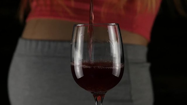 Pregnant women drinking red wine. Third trimester. pregnancy and alcohol concept. slow motion