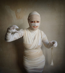 woman wrapped in bandages as egyptian mummy halloween costume fletching teeth