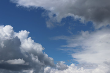 Clear blue sky with cumulus and cirrus clouds. Sunny weather with dark clouds. Joyful mood. High pressure. Clean air ecology. Water in a gaseous state. The source of rain and hail. Weather prediction.