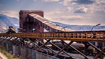 Fototapeta premium Panoramic view of old abandoned industrial zone with old wagons and conveyor.Lots of old and rusted stuff. Bakar, Croatia, Europe. .