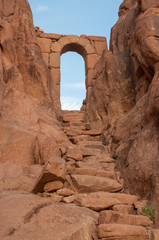 Old stone path with arch under in the desert, Egypt