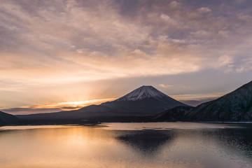 Fototapeta na wymiar Lake Motosu and Mount Fuji at early morning in winter season. Lake Motosu is the westernmost of the Fuji Five Lakes and located in southern Yamanashi Prefecture near Mount Fuji, Japan