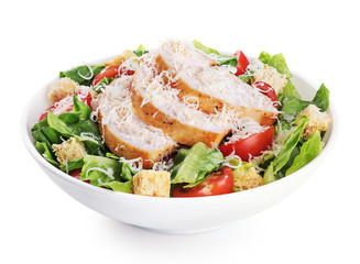 Caesar salad with chicken fillet and parmesan cheese isolated on white background.