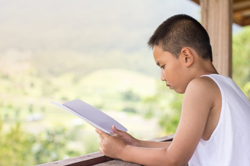Children sit reading books to find knowledge at home.