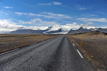 The road that goes into the snowy mountains. Iceland.
