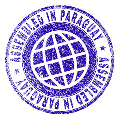 ASSEMBLED IN PARAGUAY stamp watermark with grunge texture. Blue vector rubber print of ASSEMBLED IN PARAGUAY label with scratched texture. Seal has words arranged by circle and planet symbol.