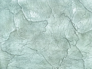 Texture decorative green plaster imitating the old peeling wall.