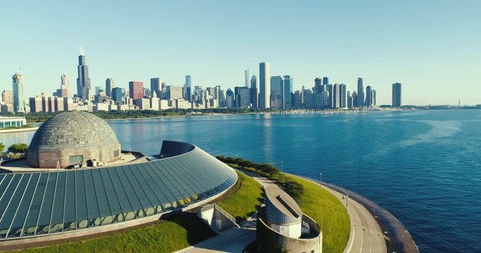 Aerial view above lakefront building to reveal Chicago skyline panorama