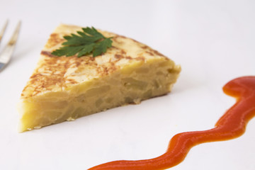 traditional spanish omelette dish with tomato sauce