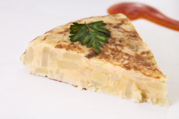 traditional spanish omelette dish with tomato sauce