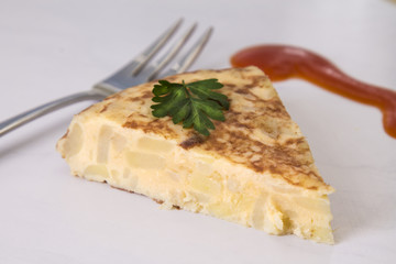 traditional spanish omelette dish with tomato sauce