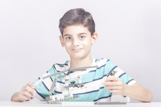 Boy creates a diy mechanical helicopter model. STEM education concept