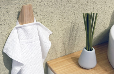 Clean Colored towels hanging on the rack in the bathroom. Focus on the top of the hook and towels