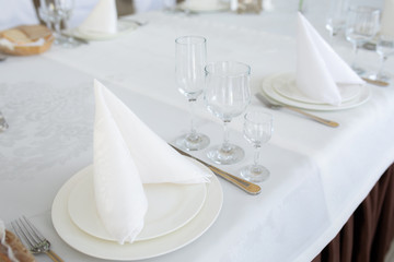Table with decoration dish cutlery in bright room