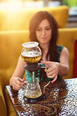 girl pours green tea in the restaurant