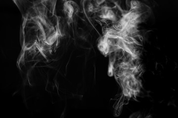 smoke from incense in front of black background