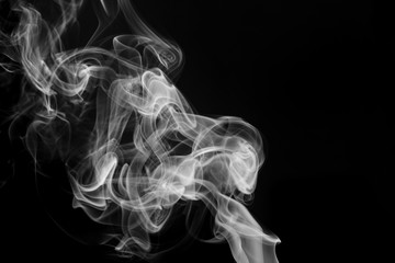 Fototapeta premium smoke from incense in front of black background