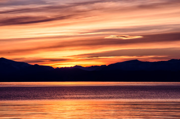 Fototapeta premium Beautiful sunset above the sea and mountain