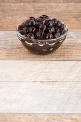 Tapioca Pearl , Bubble topping for tea or other beverage, in a cup, place on wooden table. Copy space