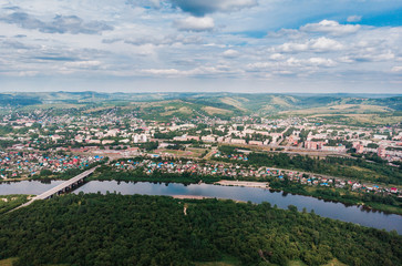 Osinniki, RUSSIA - July 17, 2018: Aerial photography of city in Kemerovo region, city near river