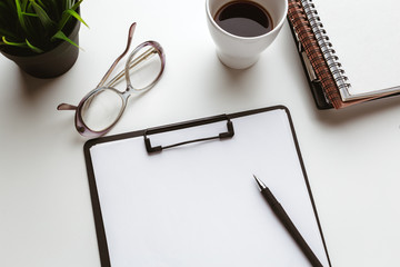 Business Items dropped in creative Disorder on white Table
