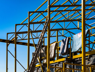 the yellow ladder on a steel frame with mattresses