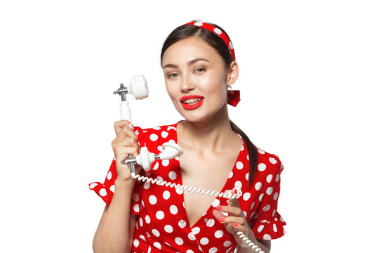 Portrait of beautiful young woman with phone, dressed in pin-up style.