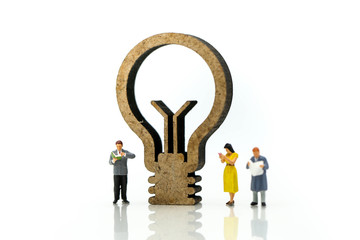 Miniature people : reading a book with sign of lamp idea and world map,Education business concept.