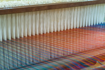 Fototapeta premium Weaving loom and shuttle on the warp