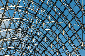 Structure of metal steel roof frame in building on blue sky background