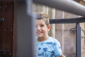 Cute little boy smiling happy looking at camera outdoors