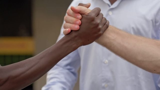 All colors friendship. black and white people hands shaking