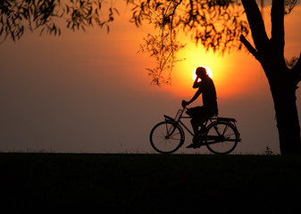 Obraz premium Shadow of cyclists with beautiful sun