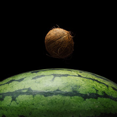 View of Earth from the moon surface. Watermelon and coconut background. Abstract space fruit concept.
