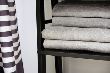 Clean Colored towels hanging on the rack in the bathroom. Focus on the top of the hook and towels