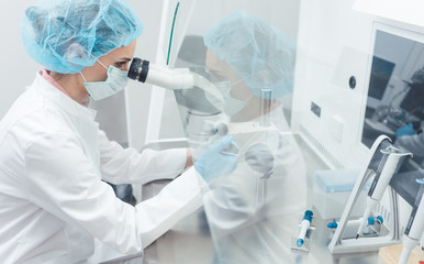 Doctor or scientist working on biotech experiment in laboratory
