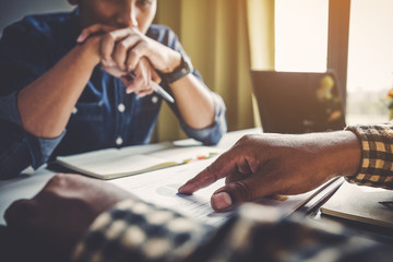 Fototapeta premium Discussing plan and idea to improvement strategy, businessmen brainstorming for strategy of business investment,businessmen review chart and document of investment information