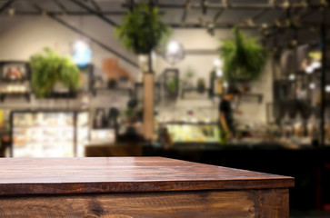 Selected focus empty brown wooden table and Coffee shop or restaurant blur background with bokeh image. for your photomontage or product display