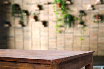 Selected focus empty brown wooden table and Coffee shop or restaurant blur background with bokeh image. for your photomontage or product display