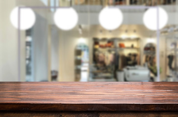 Selected focus empty brown wooden table and Coffee shop or restaurant blur background with bokeh image. for your photomontage or product display