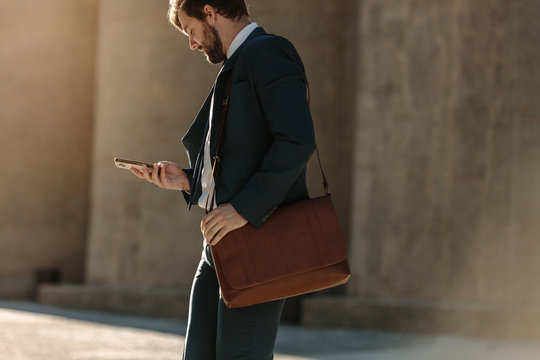 Man Using Mobile Phone While Commuting To Office