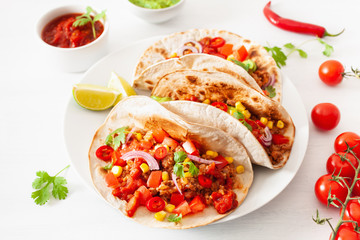 mexican beef and pork tacos with salsa, guacamole and vegetables