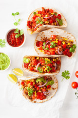 mexican beef and pork tacos with salsa, guacamole and vegetables
