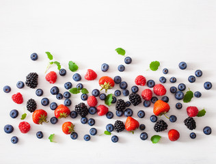 assorted berries over white background. blueberry, strawberry, raspberry, blackberry