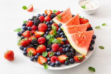 fruit and berry platter with yogurt over white. blueberry, strawberry, raspberry, blackberry, watermelon